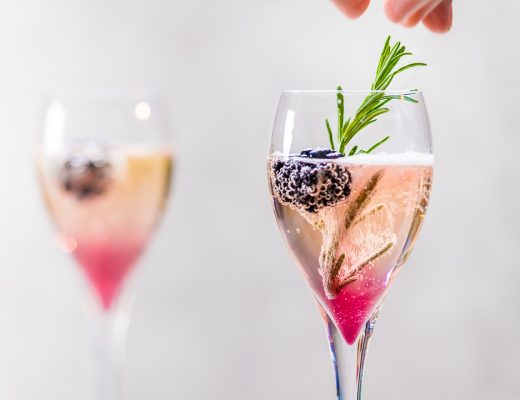 Champagne cocktail with blackberries and rosemary