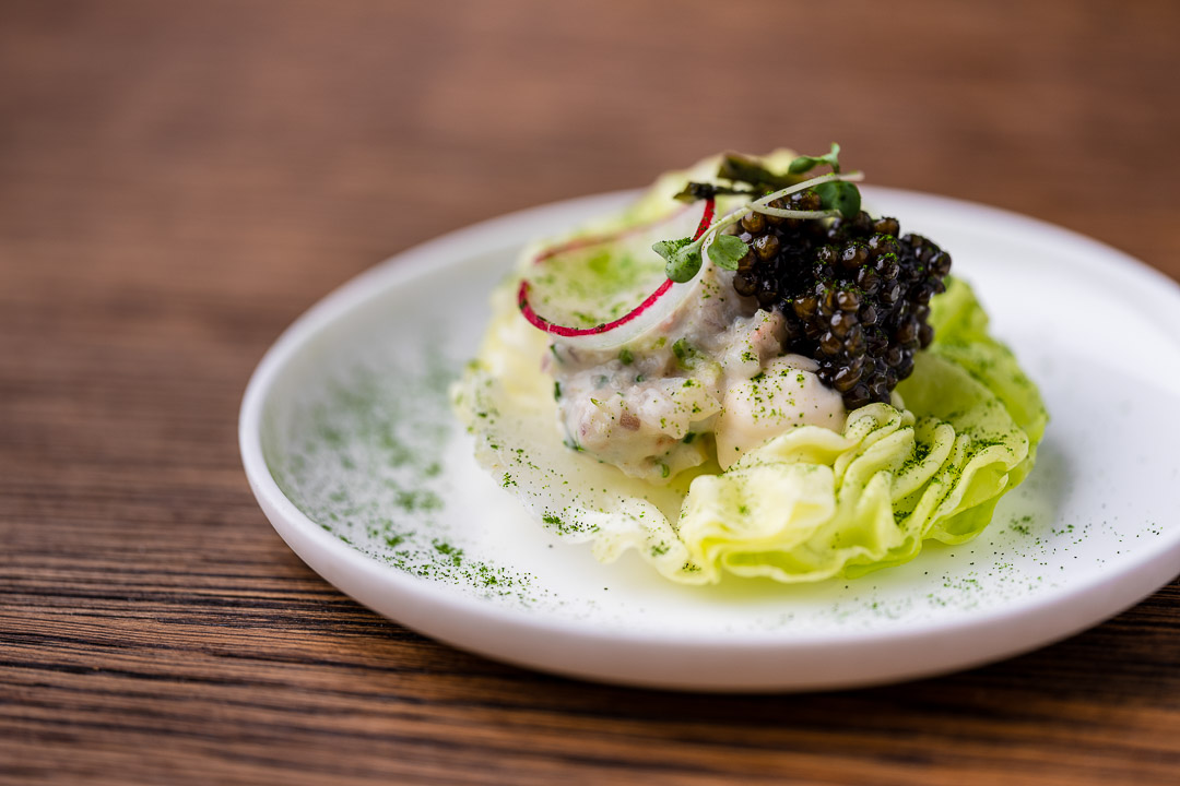 Langoustine, broccoli, onion, green nori and caviar at Restaurant Daalder in Amsterdam. Close-up.