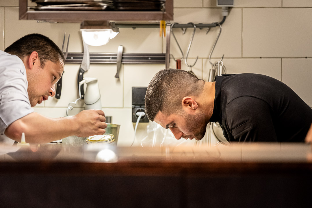 Dennis Huwaë and staff preparing food in the kitchen at Restaurant Daalder in Amsterdam