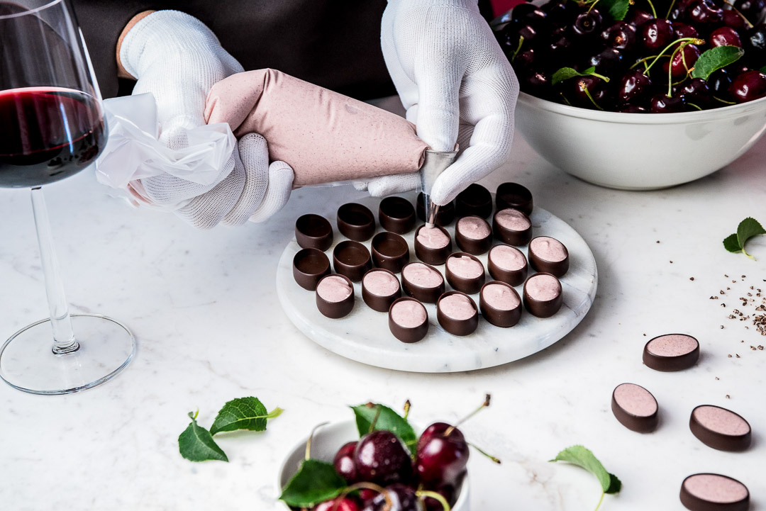Neuhaus x Sepideh by Hungry for More. Chocolatier Olivier fills the chocolates with ganache.