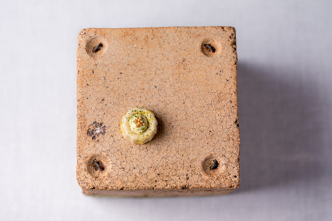 Aponiente by Hungry for More. Sardine canelé, classic petit fours from Bordeaux, made of dried sardines and mustard. Top view.