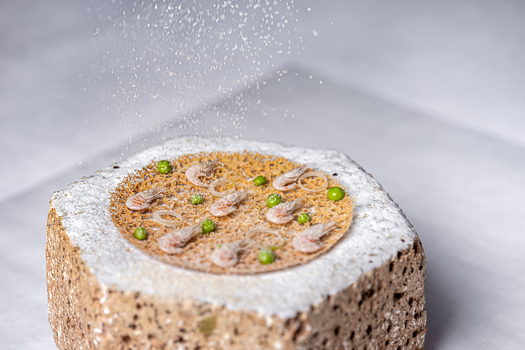 Aponiente by Hungry for More. Shrimp fritter, the iconic récipe from Cadiz with the same traditional ingredients, baby shrimp, spring onion, chickpeas flour and parsley. Front action view.