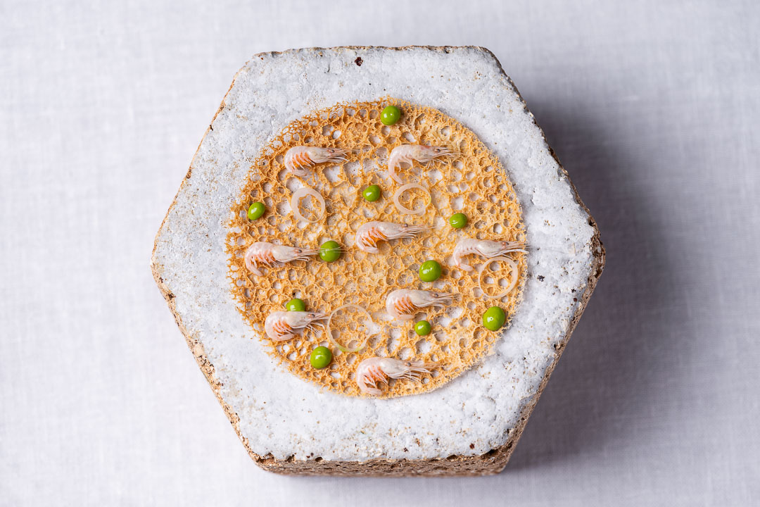 Aponiente by Hungry for More. Shrimp fritter, the iconic récipe from Cadiz with the same traditional ingredients, baby shrimp, spring onion, chickpeas flour and parsley. Top view.
