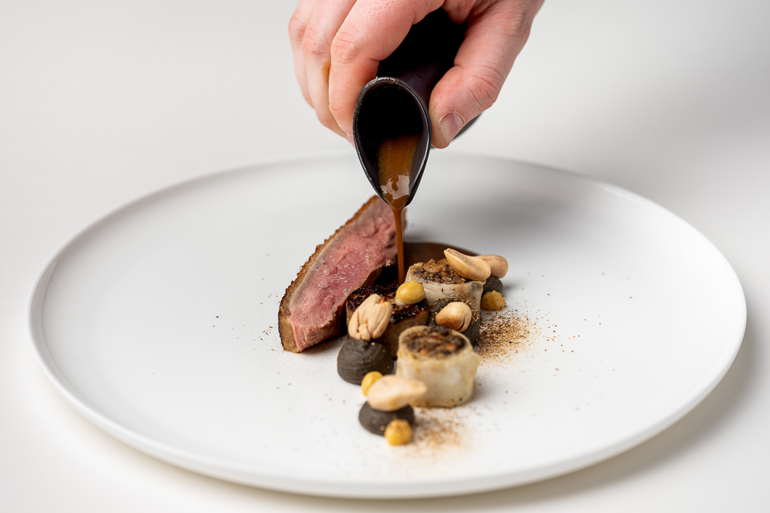 La Canne en Ville by Hungry for More. Chef Kevin Lejeune pouring the sauce on the main dish with duck.